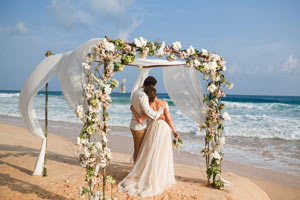 Couple under arch at overseas wedding