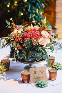 Summer wedding centre piece surrounded by candles