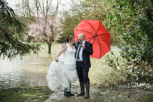 Jodie & Richard on their wedding day dancing in the flood water at Ironbridge Hotel
