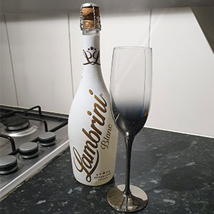 Lambrini Blanc bottle and champagne glass