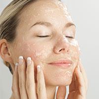 Women using beauty products on face