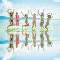 Girls jumping in ocean in Ibiza