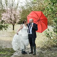 Jodie & Richard on their wedding day dancing in the flood water at Ironbridge Hotel
