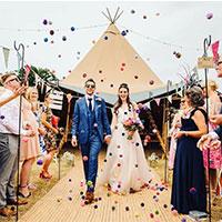 Couple in front of camper van at wedding fair