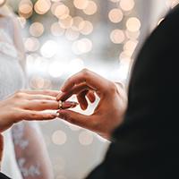 Man giving woman wedding ring