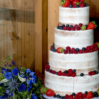 Stable Cottage 4 tier Vegan Wedding Cake with summer berries and flowers