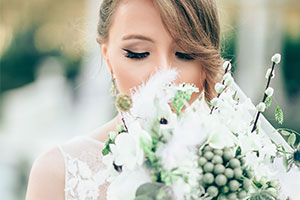 A guide to summer wedding photography - bride smelling bouquet